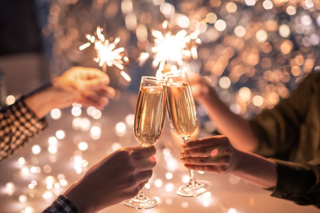 Hands of couple with flutes of champagne