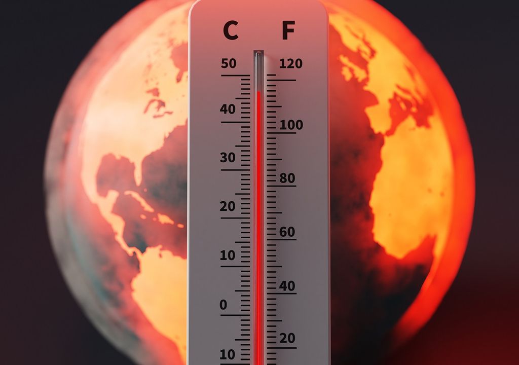 planeta al rojo atrás de un termómetro marcando casi 50 grados Celsius