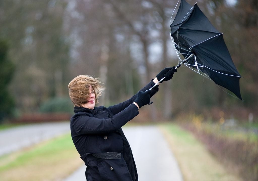 persona con paraguas; viento fuerte