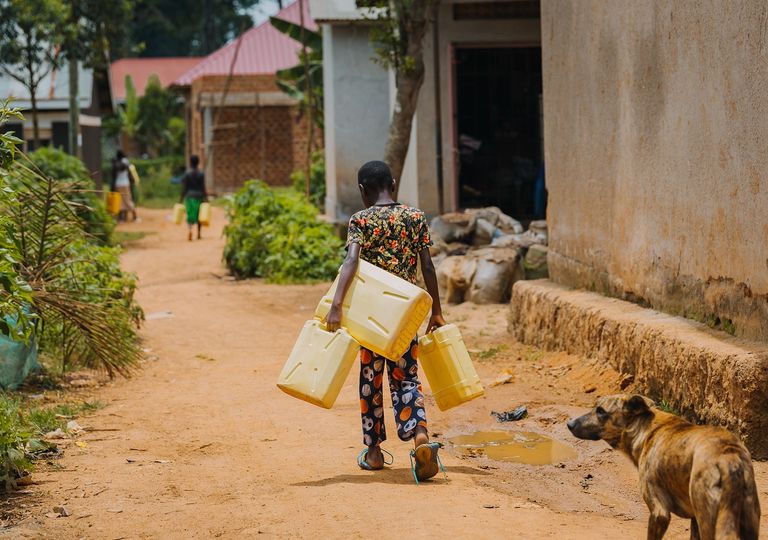 Niños cargando bidones para buscar agua. Niños cargando bidones para buscar agua.