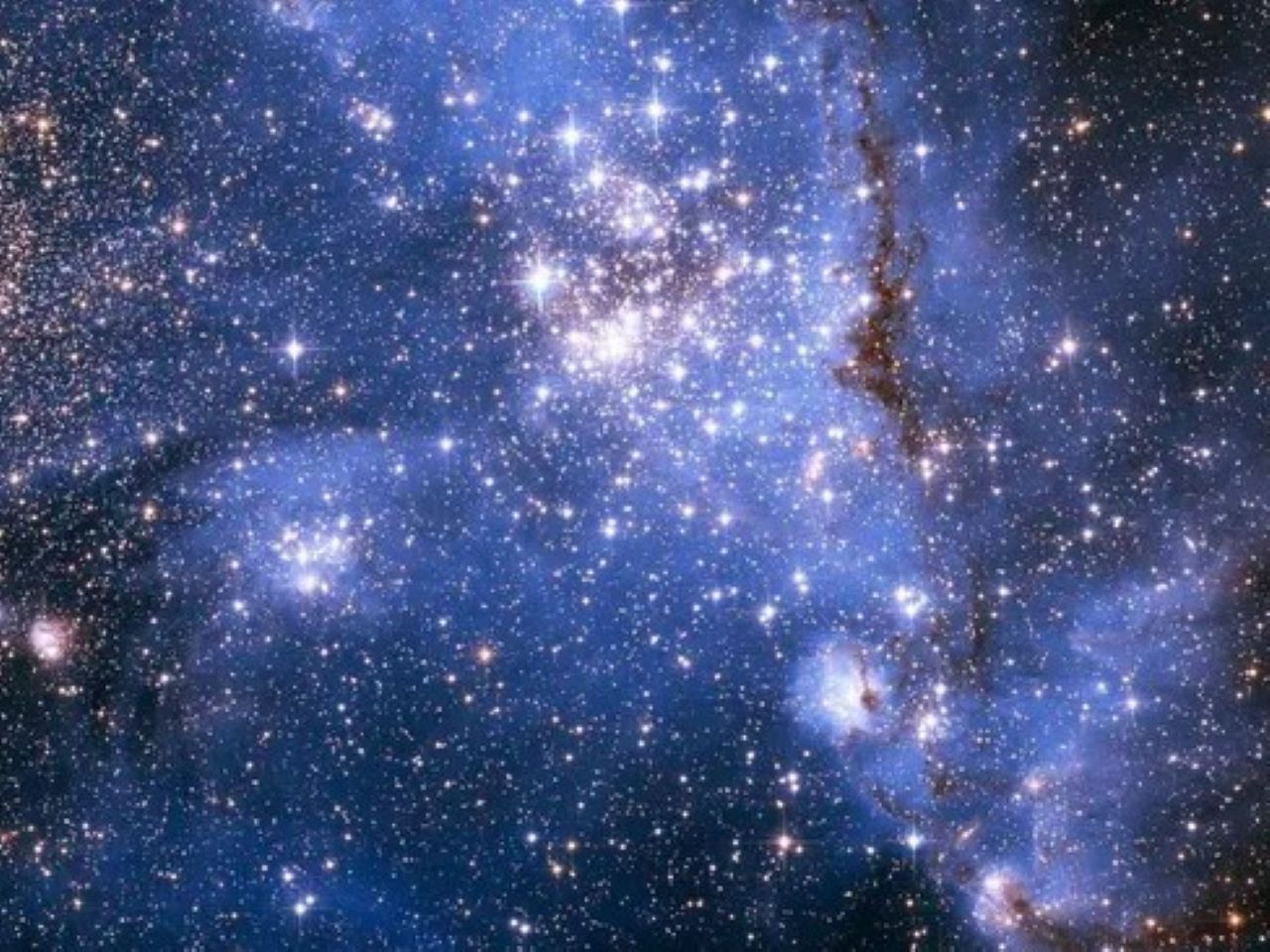 Estrellas densamente empaquetadas y gas brillante en la región de formación estelar masiva NGC 346 en la Pequeña Nube de Magallanes. Crédito: NASA, ESA, A. James (STScI).