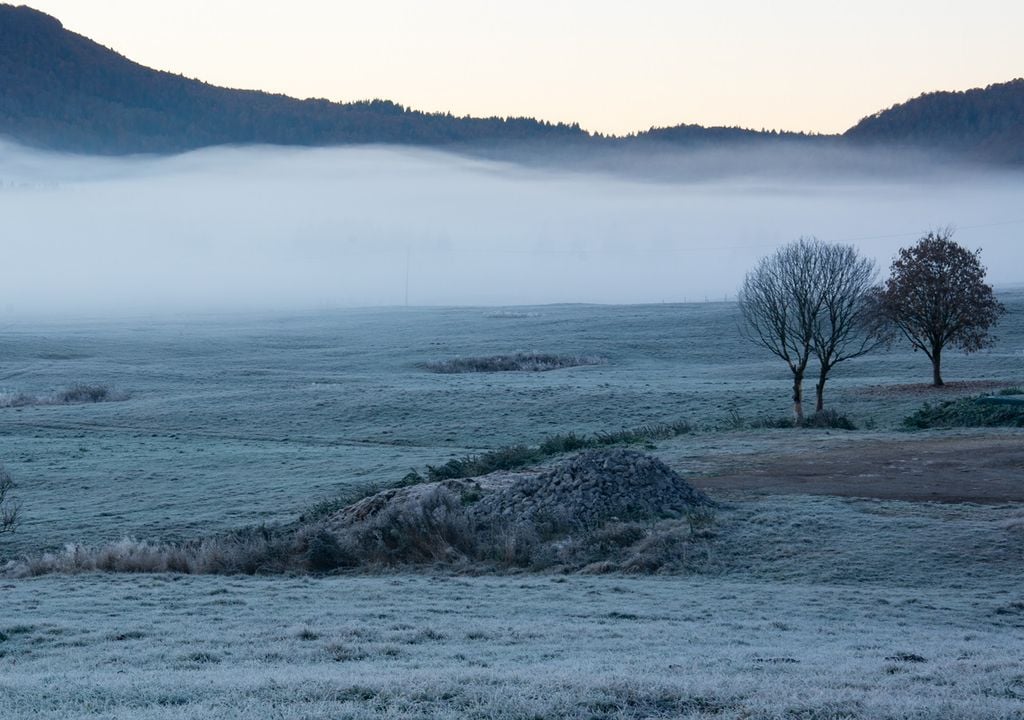 valle con banco de niebla y escarcha