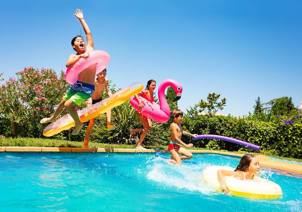 Niños saltando a la piscina; verano; calor