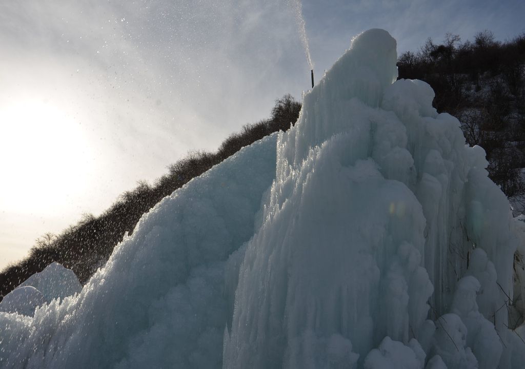 The artificial glacier is the result of water from a pipe freezing