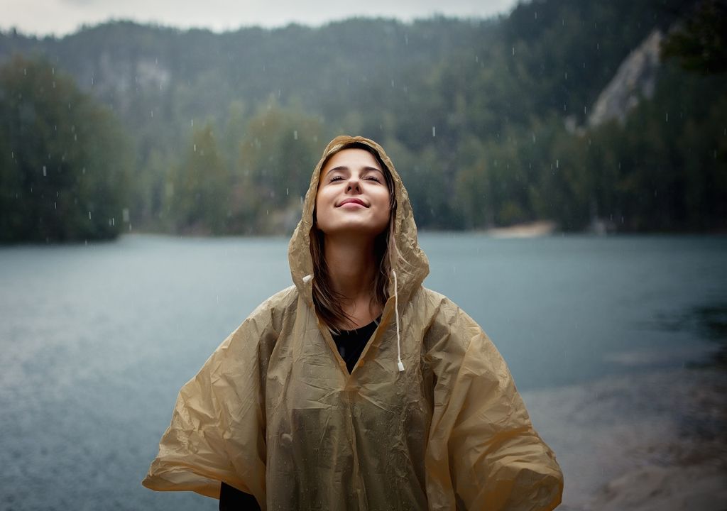 persona disfrutando de la lluvia en zona lacustre