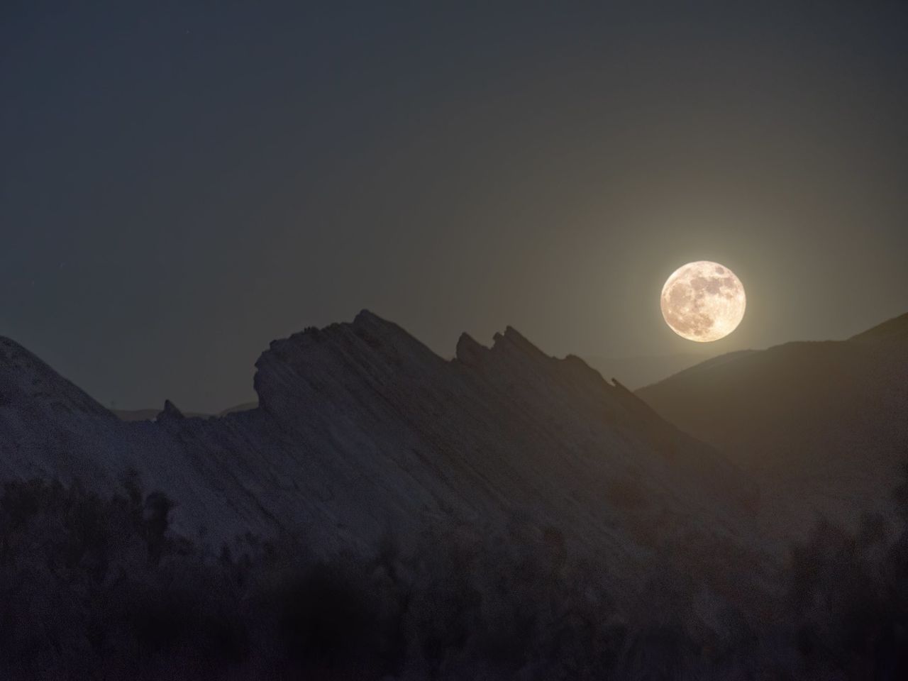 La luna llena se alza sobre el parque natural Vasquez Rocks en Santa Clarita, California. Crédito: NASA/Preston Dyches