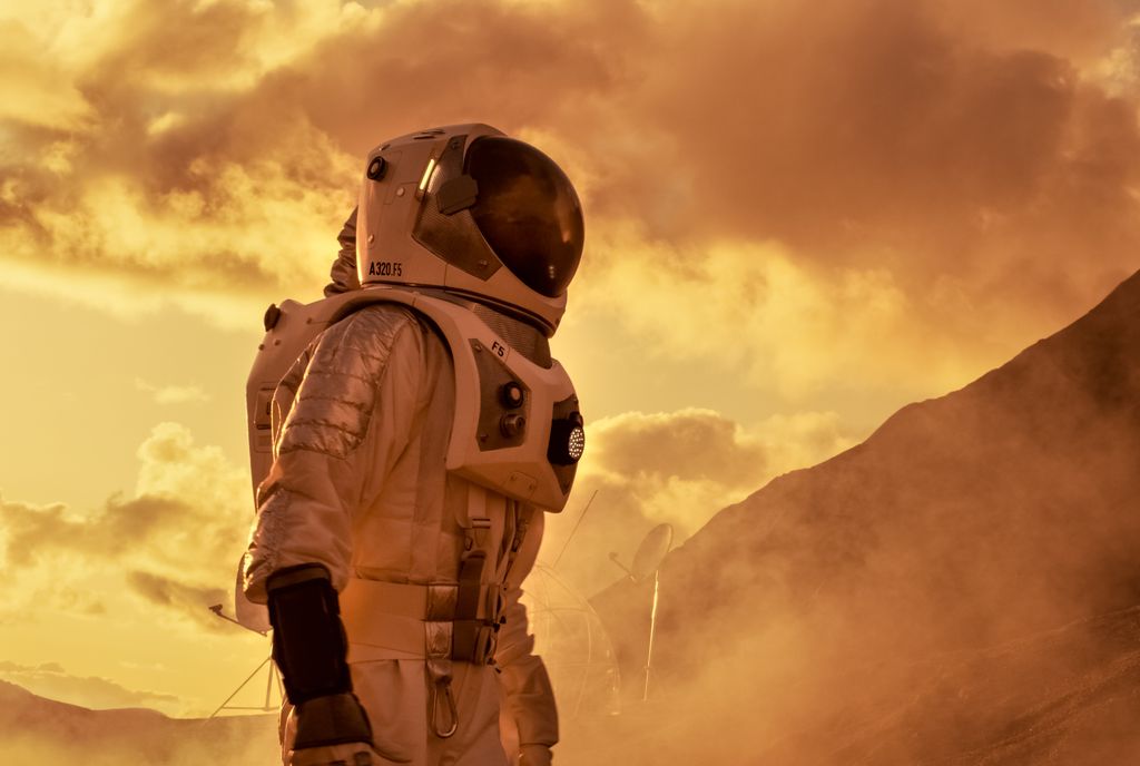 Astronaut in the Space Suit Explores Red Planet Mars