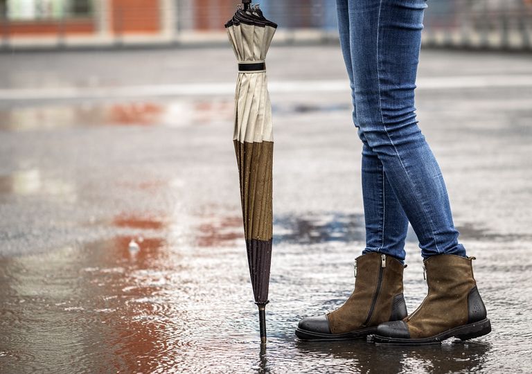 mujer en pie bajo la lluvia mujer en pie bajo la lluvia