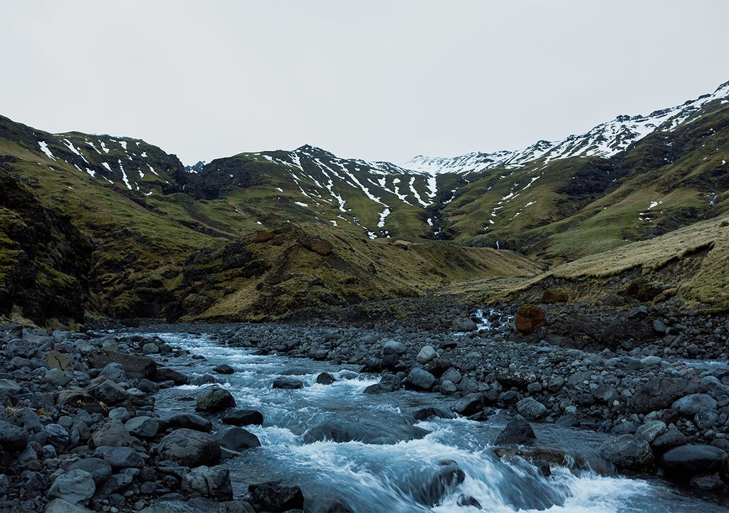 Snow capped mountains and a stream