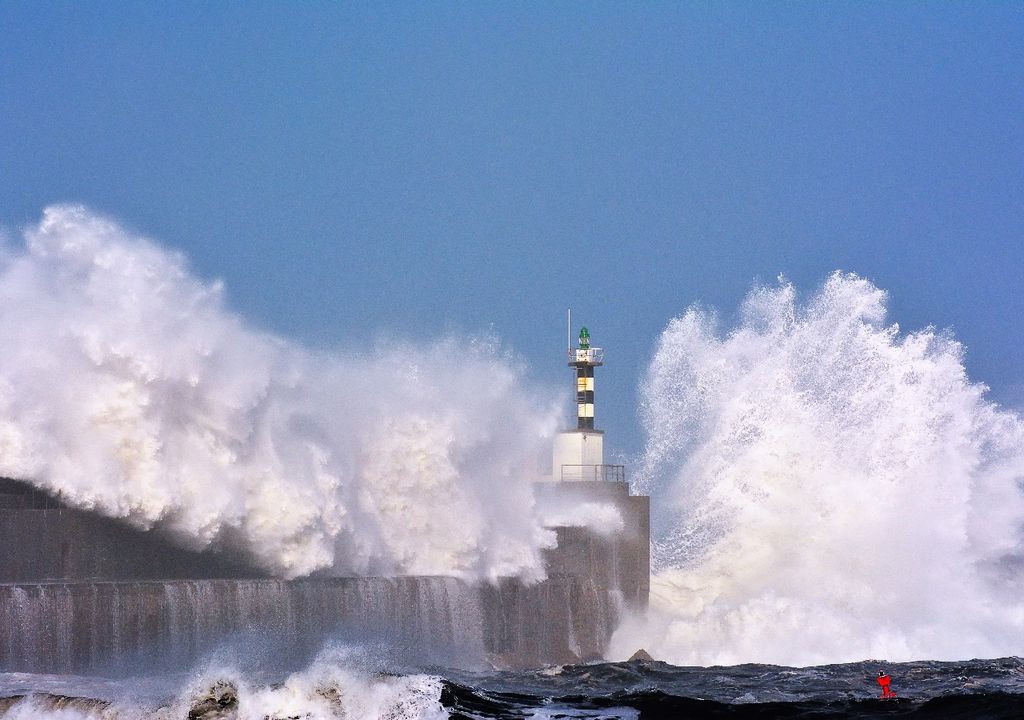 Giant wave hitting lighthouse