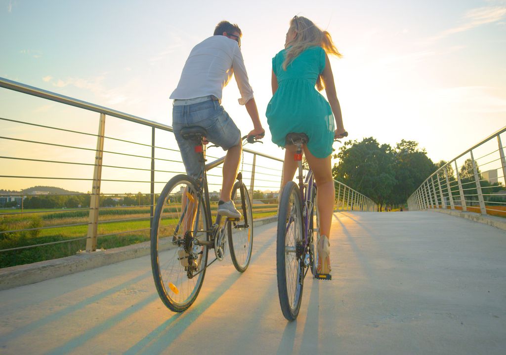 Couple ride bikes in the sun