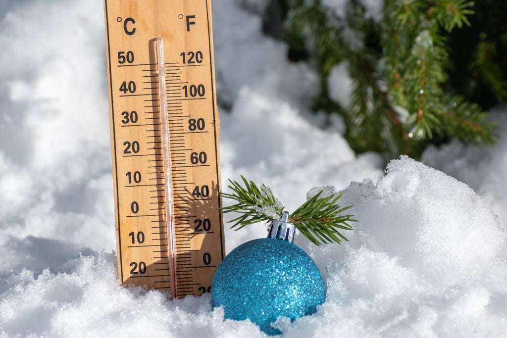 Christmas toy ball near tree and thermometer